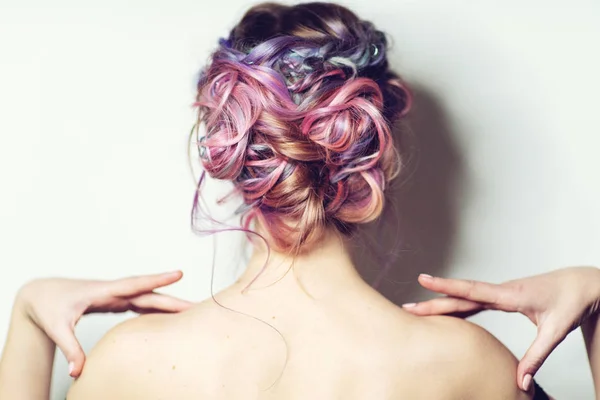 Back view of young woman with modern hairstyle with colorful haircut. — Stock Photo, Image