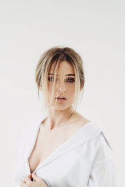 Beyaz bir arka plan üzerinde erkek gömlek güzel genç kadın