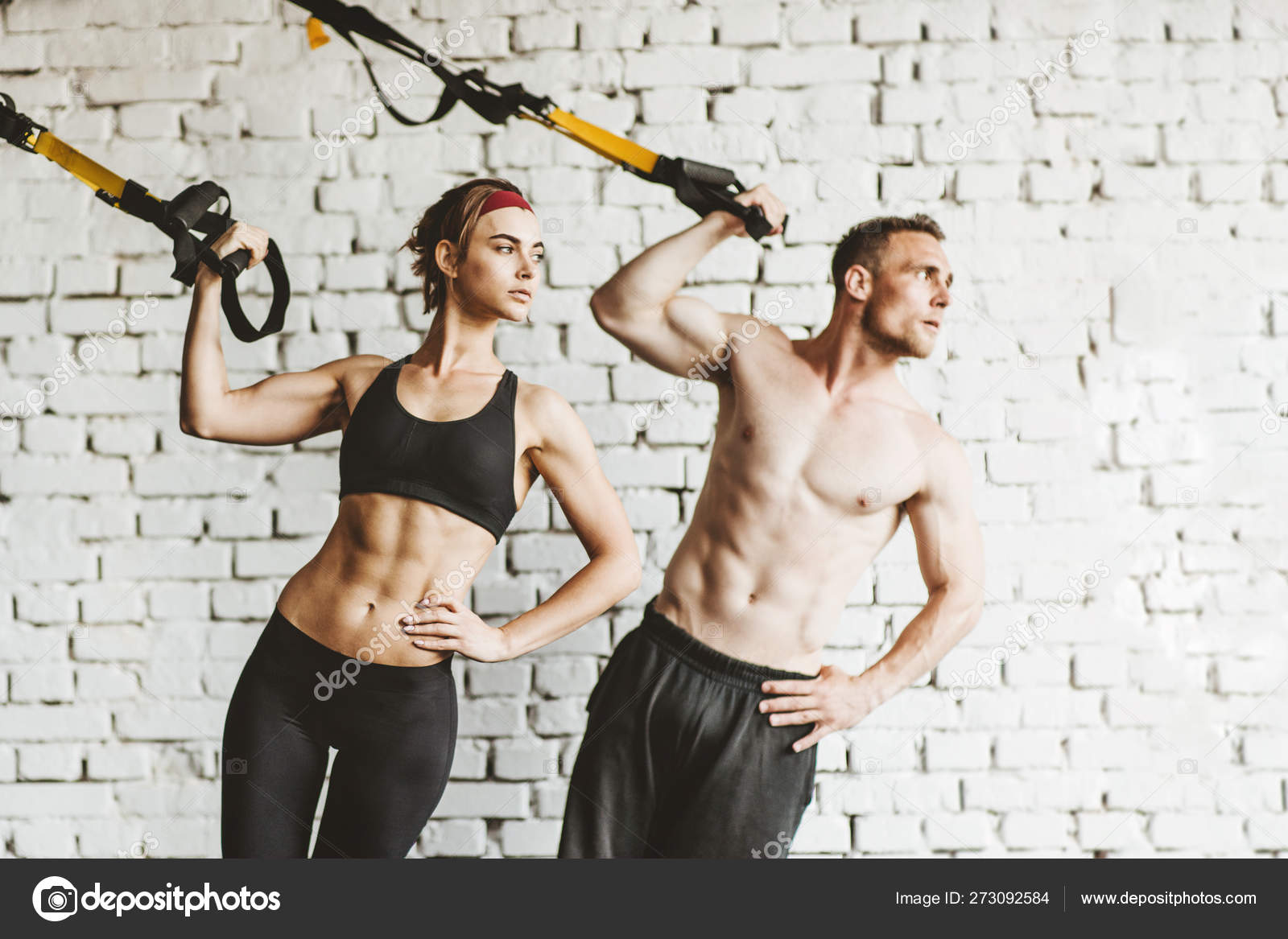 Athletic man and woman doing TRX workout at gym. — Stock Photo © Ablozhka  #273092584