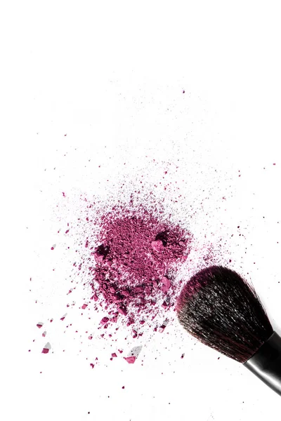 Purple crushed eyeshadow and professional make-up brush