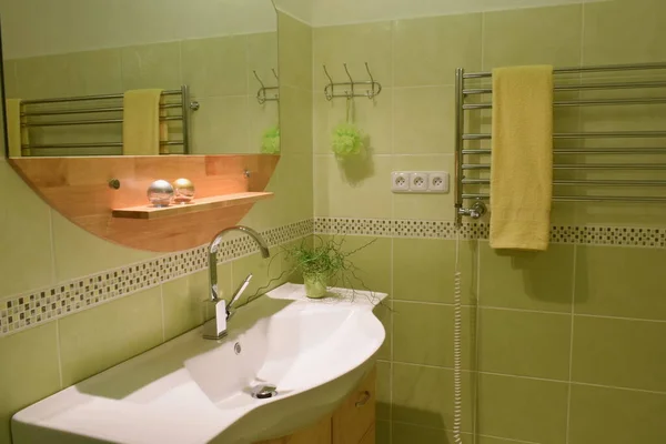 Green fresh bathroom in vintage style with washbasin and mirror