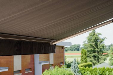 Sunprotecting awning from fabric material, residential house. clipart