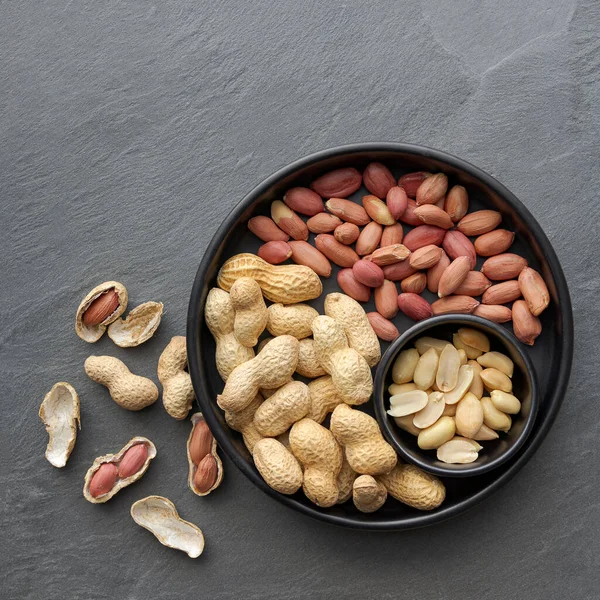 flat lay of roasted unsalted peanuts, peanuts in skin and peanuts in shell, food ingredients, Arachis hypogaea