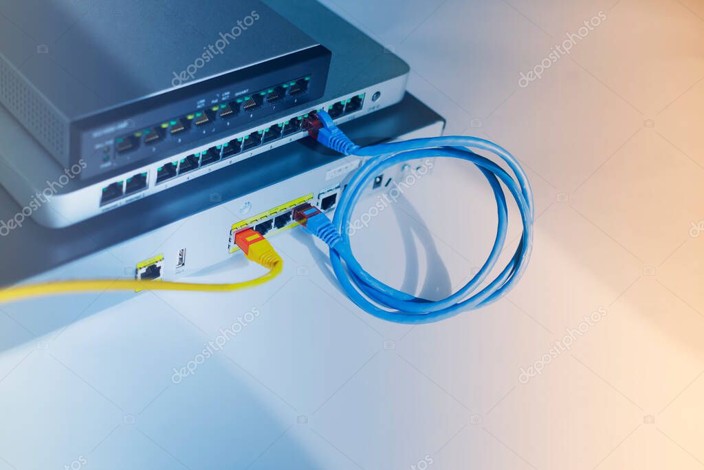 Enterprise equipment concept. Black and silver  cloud switches interconnected using bright cables on the white background. Rack mount routers. Space for your text. Closeup.