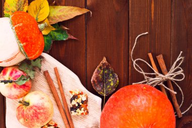  Ahşap arka planda akçaağaç yapraklı balkabağı, elma ve fındık seti. Sonbahar havası. Şükran Günü konsepti Sağlıklı yemek, diyet, yaşam tarzı ve tatil teması. Üst Manzara. Kapat..