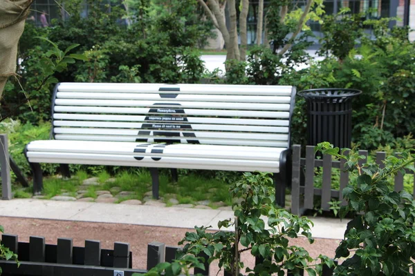 Park bench with an advertisement for social distance. \