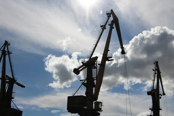 Silhouette of the port crane against the sky