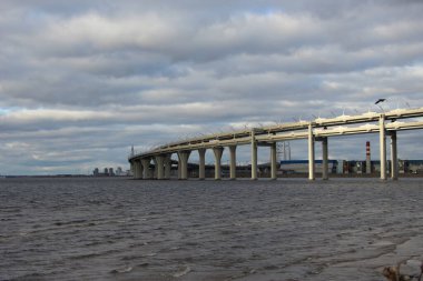 Otobandaki körfezin kıyısından gökyüzüne karşı yay üzerinde yürürken