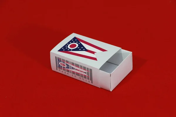 Ohio flag on white box with barcode and the color of state flag on red background, paper packaging for put match or products. The concept of export trading from Ohio.