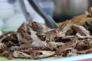 Tepside satılık çıtır balık yığını. Pirinçle yenen bir yiyecek..