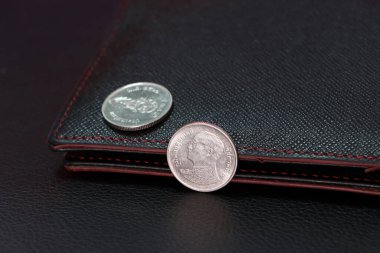 Tayland 1 baht madeni para obverse (THB) ve dışarı odaklanmak siyah cüzdan ile bir baht para, finans kavramı.
