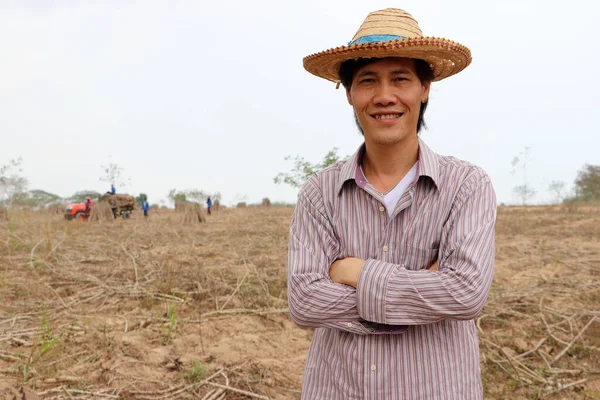 Male Farmer Standing Hugging Chest Cassava Farm Out Focus Tractor — Stock Photo, Image