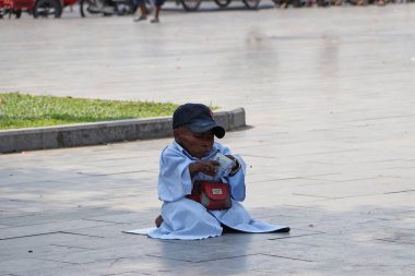 Phnom Penh, Kamboçya, 4 Şubat 2019: Engelli bedeniyle yerde para sayan dilenciler.