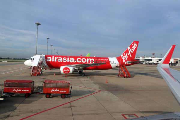 Don muang, Bangkok, Thailand, June 6, 2018 : The plane of Thai Airasia, Airbus A320  is parked on the parking lot and against the passenger boarding staircase to the door.