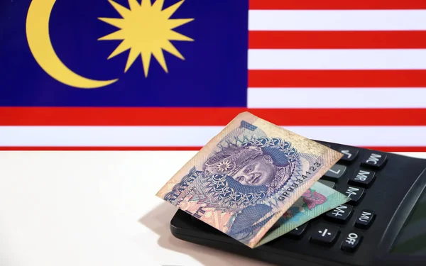 Один Ринггит Банкноты Малайзии Калькуляторе Белом Полу Фоном Флага Малайзии — стоковое фото