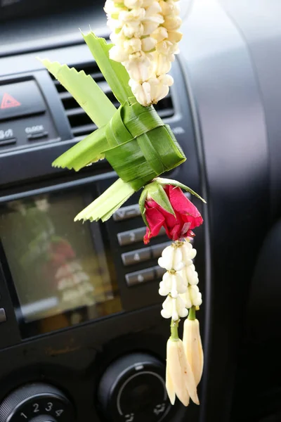 flower garland contains of basket carp from banana leaf, crown flower, Jasmine, rose and Chempaka hanging in the car. Fortunately for safe travel and good luck.