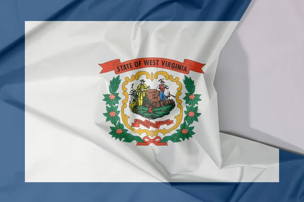 West Virginia fabric flag crepe and crease with white space. A pure white field bordered on four sides by a stripe of blue with the coat of arms of West Virginia in the center. The state of America.