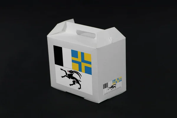 白盒上印有条形码的格劳宾登旗和黑色背景的瑞士州彩旗 从格劳宾登到纸包装的出口贸易概念 — 图库照片