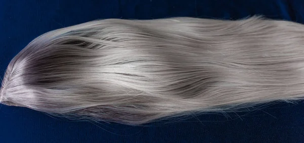 Wigs synthetic and natural hair. Blonde and ash blonde hair. Womens beauty concept