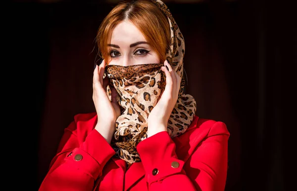 Young woman in fashionable homemade mask, scarf on her face, stop virus, save yourself