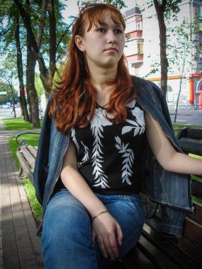 A simple ordinary average girl graduate from an American school high school graduation in the park. Young woman who have a dream.