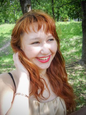 A simple ordinary average girl graduate from an American school high school graduation in the park. Young woman who have a dream.