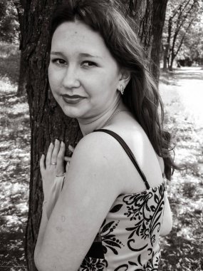 A simple ordinary average girl graduate from an American school high school graduation in the park. Young woman who have a dream.