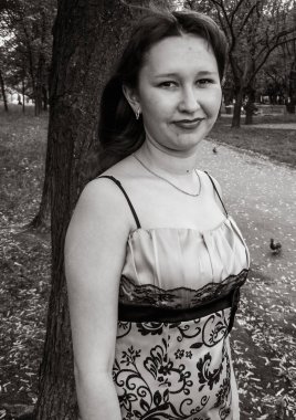 A simple ordinary average girl graduate from an American school high school graduation in the park. Young woman who have a dream.