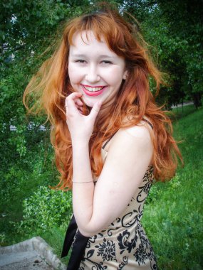 A simple ordinary average girl graduate from an American school high school graduation in the park. Young woman who have a dream.