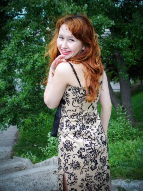A simple ordinary average girl graduate from an American school high school graduation in the park. Young woman who have a dream.
