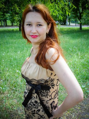 A simple ordinary average girl graduate from an American school high school graduation in the park. Young woman who have a dream. Snapshot with a fashionable vintage effect