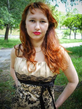 A simple ordinary average girl graduate from an American school high school graduation in the park. Young woman who have a dream. Snapshot with a fashionable vintage effect