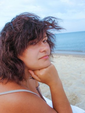 American woman plus a size resting on the seashore early in the morning enjoying the sun at the resort