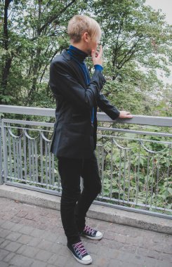 Young guy walking around and smoking, Student at city street, college or university lifestyle time