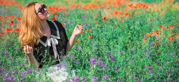 Redhead woman in vintage blouse and lace skirt at poppies field, fashionable style for ladies