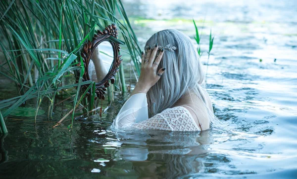 Old European magic, Mystical Pagan scene, woman in lake, rituals. Magic divination in water, ritual. Psychic vision, fortune teller