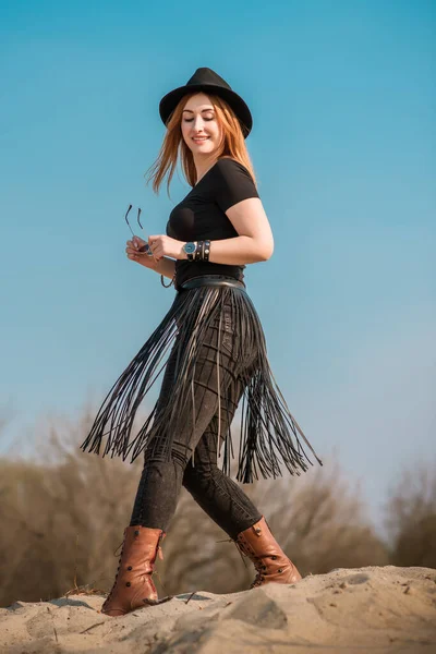 Fashionable outfit details, plus size girl with Large size in fringe belt and fedora hat mix style