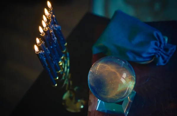 Magic crystal ball fortune teller ,love telling,  esoteric concept, mystical scene with candles, tarot cards on a table