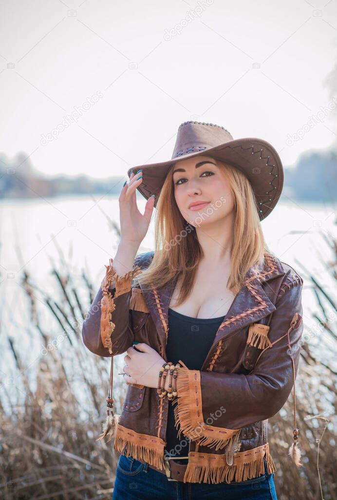Cowgirl American autumn style, full L figure woman in leather jacket, jeans and hat