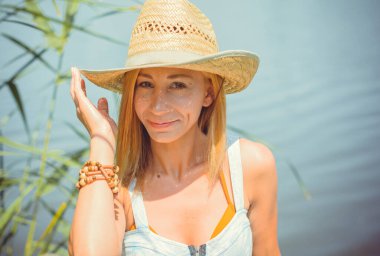 Doğal yüz rötuş yok, trend. Sarışın, romantik, sıradan ve hoş bir kız hafta sonu istirahatinde ve doğada iyi vakit geçiriyor.