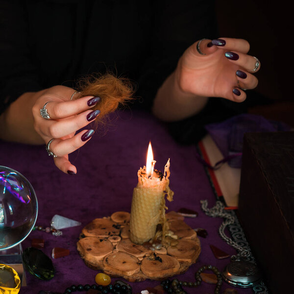 Woman make a rituals with a hair and voodoo doll , Concept of magic rituals and wicca