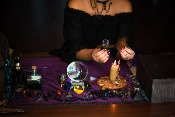 Woman make a rituals with a hair and voodoo doll , Concept of magic rituals and wicca