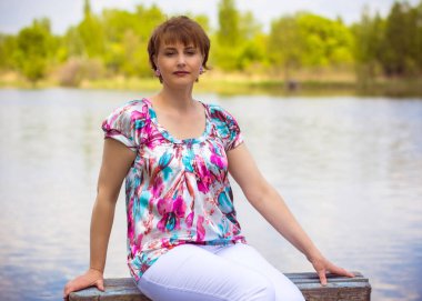 Olgun Avrupalı bir kadın haftasonu kır evine yakın bir yerde güneşli yaz günlerinde keyifli olur.