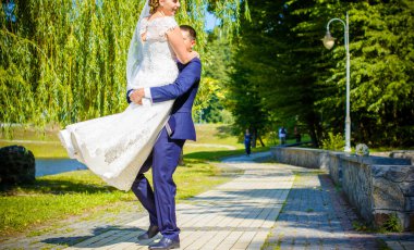 Keyifli öpücüklere sahip güzel bir düğün çifti. İhtiyacın olan tek şey aşk. Artı boyut hassasiyeti gelin ve genç damat.