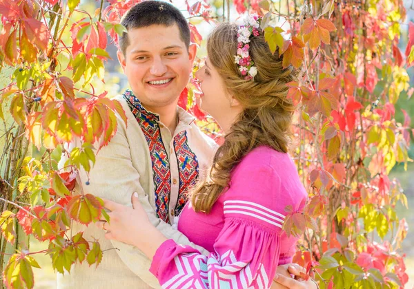 A young blonde girl with a guy in embroidered linen dress in an ethno style. Slavic beauty