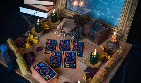 Tarot cards, candles, witch magic objects. Wicca, esoteric, divination and occult background with vintage magic stuff for mystic rituals