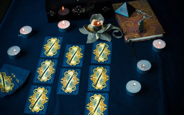 Tarot cards, candles, witch magic objects. Wicca, esoteric, divination and occult background with vintage magic stuff for mystic rituals