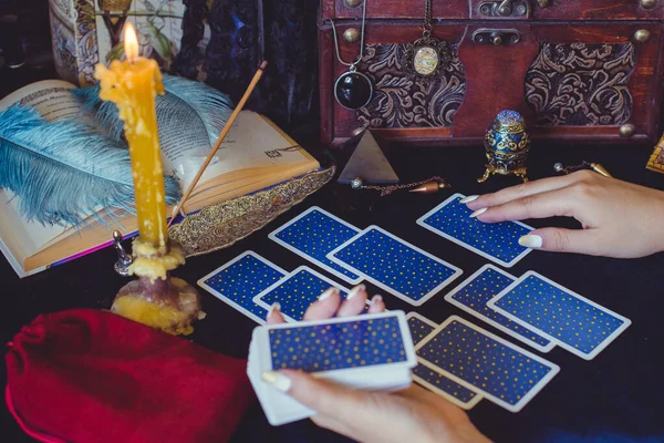 Tarot cards, candles, witch magic objects. Wicca, esoteric, divination and occult background with vintage magic stuff for mystic rituals