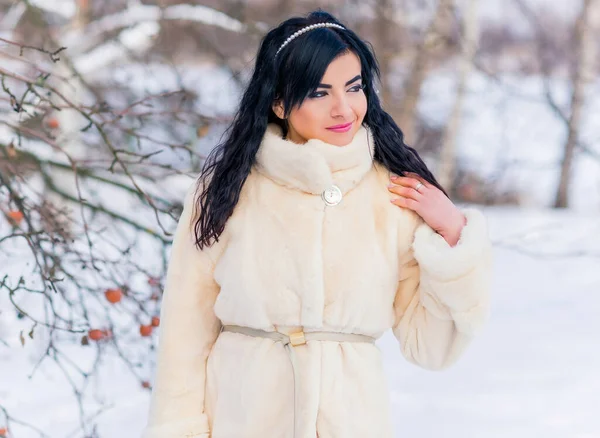Fashion concept. Beautiful arabic lady in holidays, modern woman wear fur coat look . Fashionable lady outdoors portrait