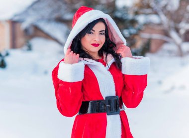 Arap Noel Baba kızı kış tatilinde, kırmızı kostümlü kız Noel tatilinde mutlu kadın kış karlı gününde eğleniyor, pozitif ruh hali kavramı